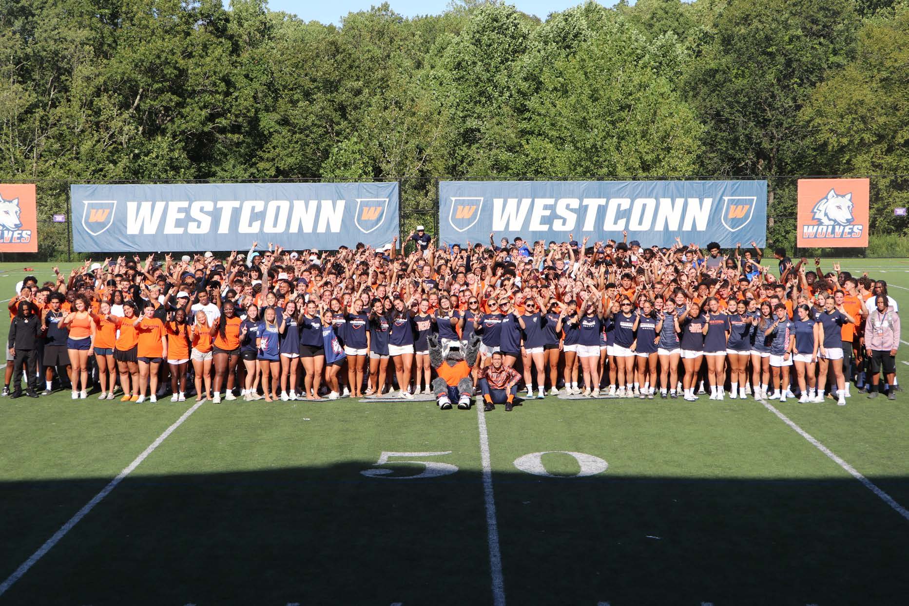 WestConn student-athletes and staff gathered on the field